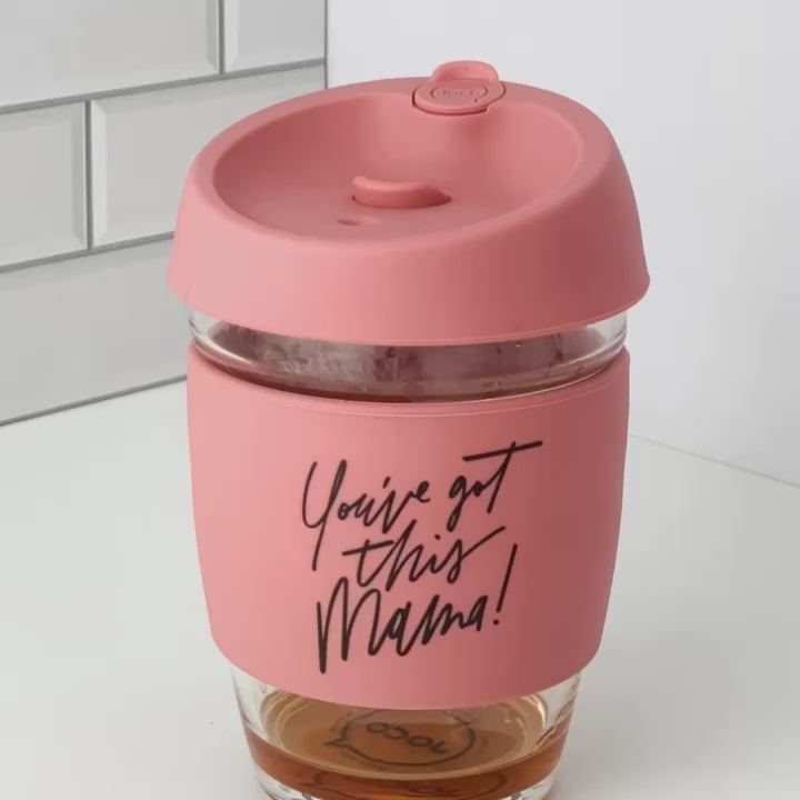 A short stopmotion video shows a pink travel mug with liquid in being tipped over on different angles. The lid has a stopper so it doesn't spill.